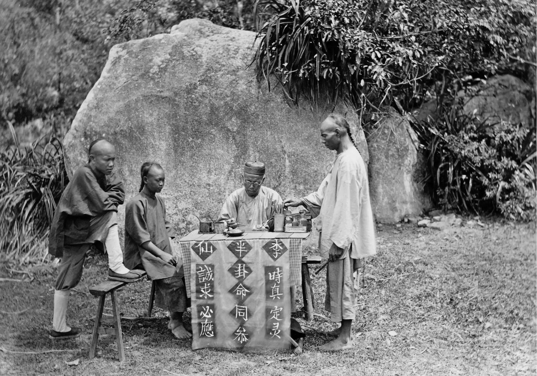 An archival photograph of an outdoor I Ching consultation
